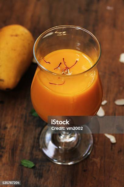 Mango Lassi With Saffron Garnish On Wooden Background Stock Photo - Download Image Now
