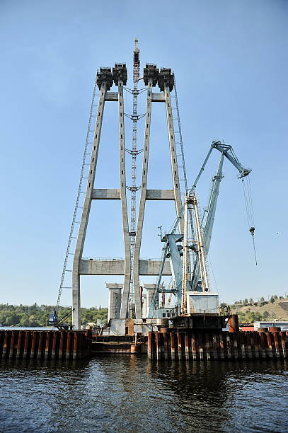 istock construction of a bridge across the river 535792898