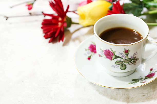 istock Coffee in floral tea cup with flowers in background 535796078