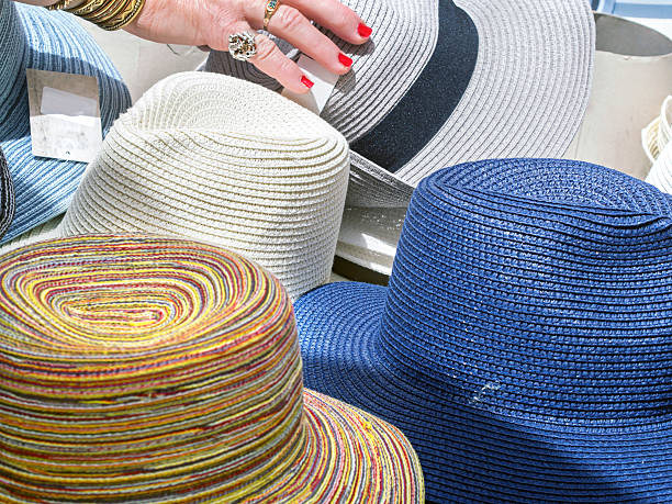 woman's hand grabbing  hat at the market stock photo