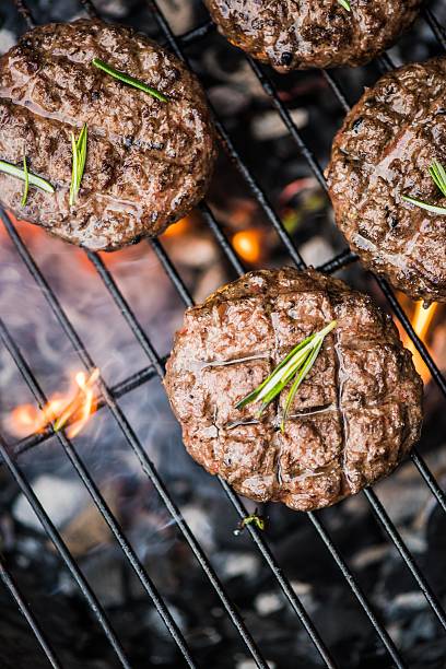 istock beef burgers on grill with flames 535797794