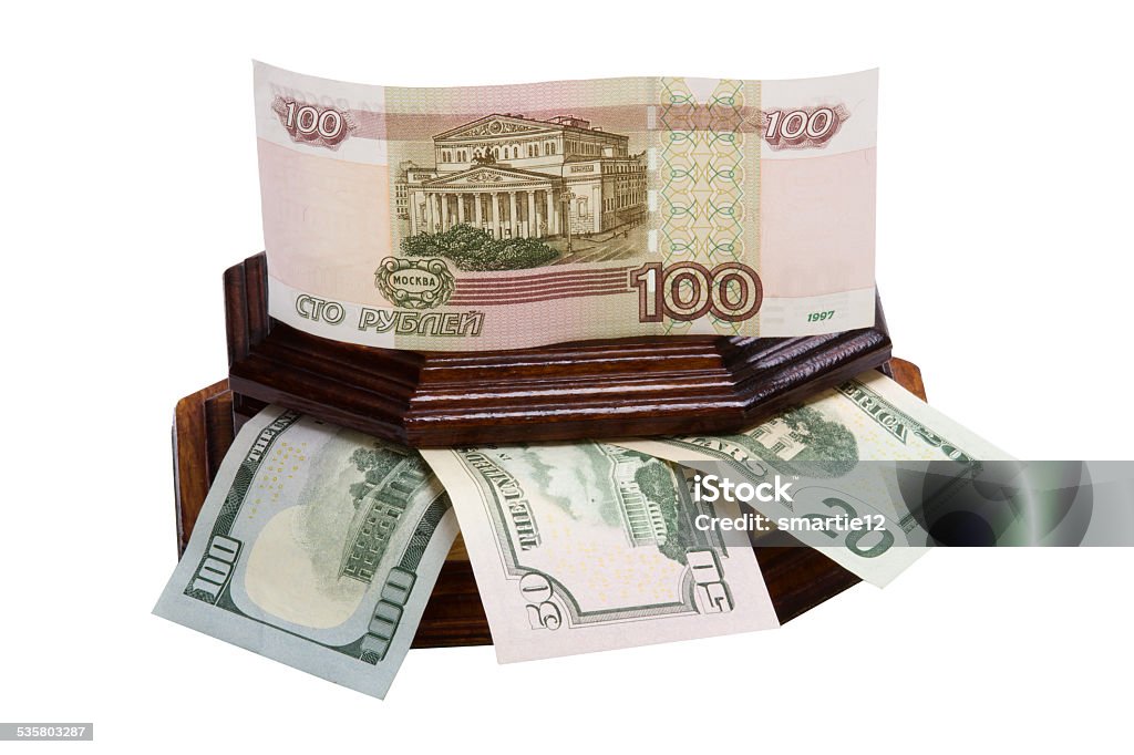 Money in a box Money in a box rubles and dollars are isolated on a white background. 2015 Stock Photo