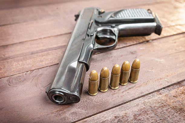 istock Semi-automatic 9mm gun isolated on wooden background 535806963