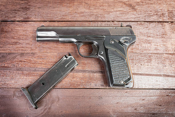istock Semi-automatic 9mm gun isolated on wooden background 535806965