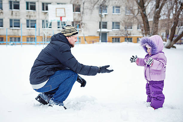 istock Father and daughter in winter park 535808967