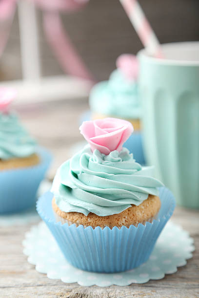 istock Tasty cupcake on grey wooden background 535810959