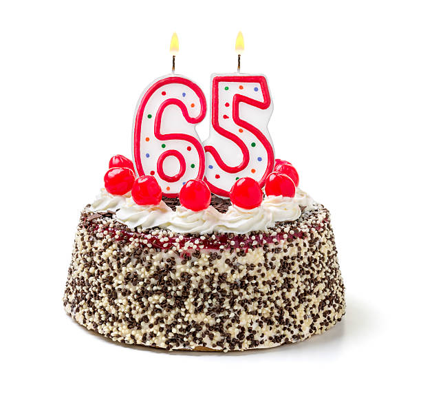 Birthday cake with burning candle number 65 Birthday cake with burning candle number 65 65 69 years stock pictures, royalty-free photos & images