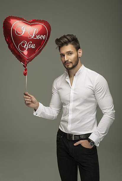 istock Handsome man with balloon heart 535810991