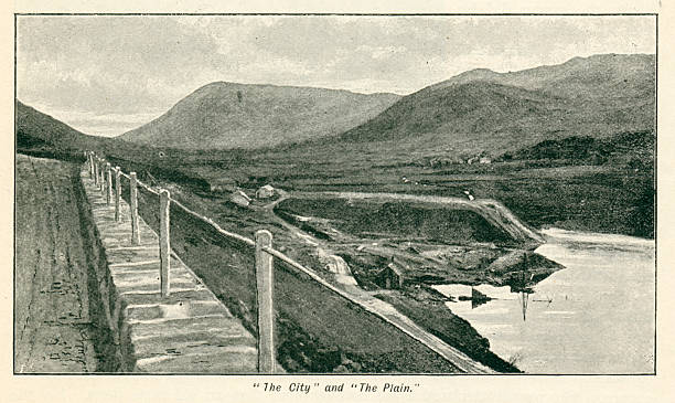 This 1894 photograph from Thirlmere in the English Lake District is taken from (The Pall Mall Magazine 1894). Its title is 'The City' and 'The Plain'. Thirlmere reservoir was constructed in the 19th century to provide the city of Manchester with water, which it does to this day.  The area flooded by the creation of Thirlmere was previously occupied by two smaller lakes, Leathes Water and Wythburn Water. The water level was raised by construction of a dam at the northern end of Thirlmere in 1890–1894. The construction of Thirlmere would have been underway at the date when this map was created. The map shows, by way of a dotted line, the area that will be covered over with water after the creation of the dam. The water level was raised by fifty feet / fifteen metres. After strong local opposition, an Act of Parliament was passed in 1879 allowing the construction to begin.