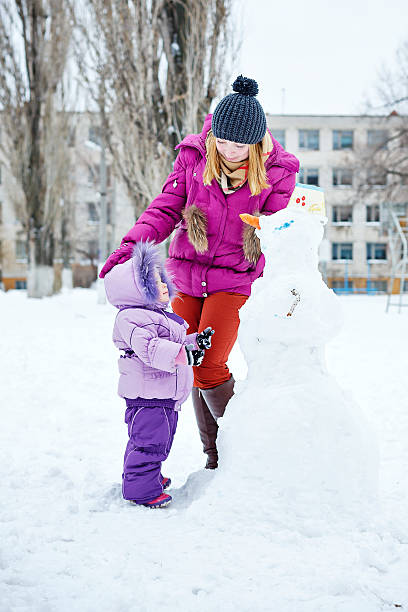istock Mother and daughter in winter park 535813175