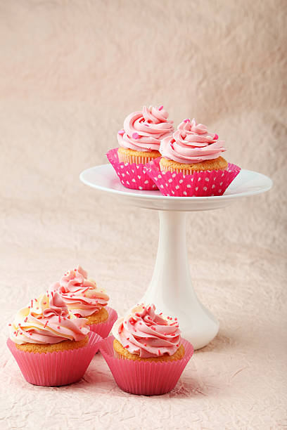 istock Tasty cupcake on pink background 535814571