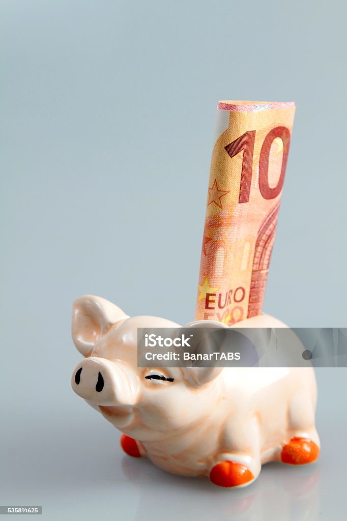 Piggy Bank Insert Euro Small piggy bank with Euro isolated in blue. 2015 Stock Photo