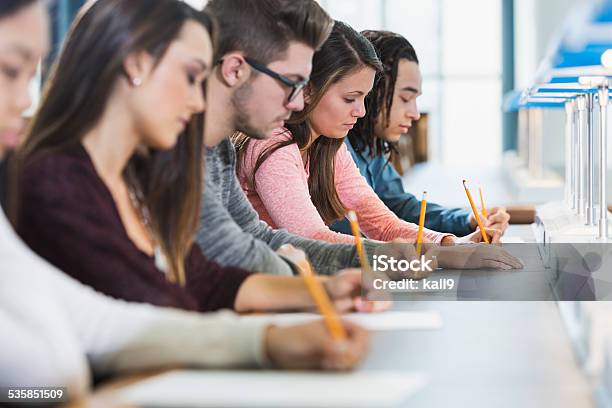 Group Of Teenagers Taking A Test Stock Photo - Download Image Now - Educational Exam, Student, Teenager