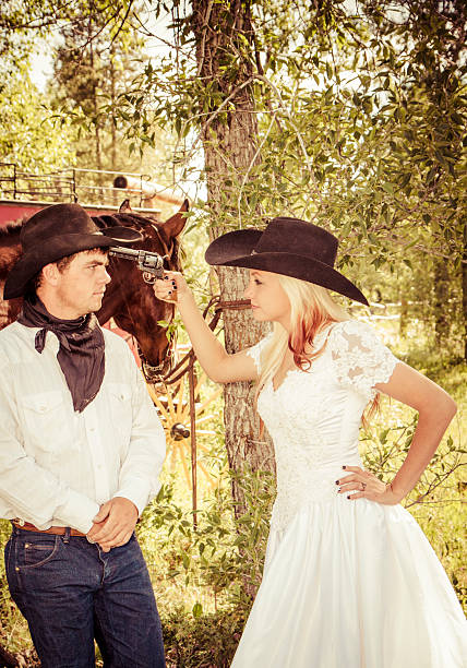 istock Bride Pointing A Gun At Her Husband At Their Wedding 535851819