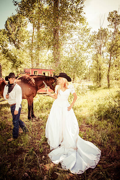 istock Bride And Groom Pointing Pistols At Each Other - Wedding 535851825