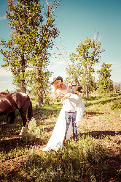 istock Cowboy Groom Carrying His Bride 535851839