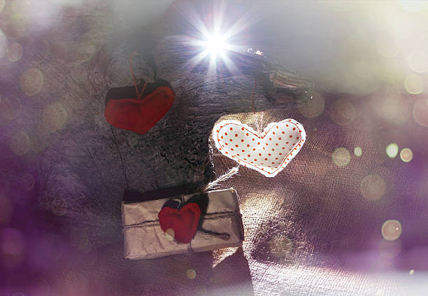 istock hearts and gift on wooden background with flash Light 535852343