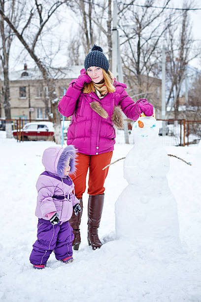istock Mother and daughter in winter park 535854233