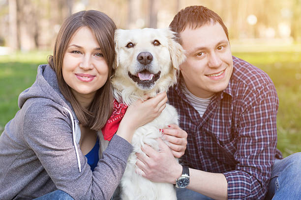 istock Smiling young man and woman hugging a dog 535867003