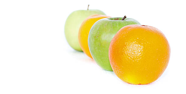 istock Row of oranges and green apples on white background. 535867565