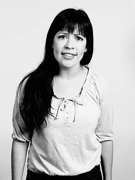 istock Dimpled brunette looks irritated, frowning. Black and white image 535869651