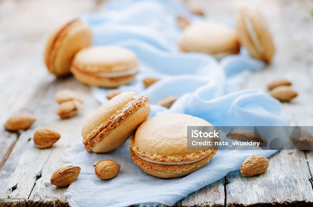 macaron with cream cheese macaron with cream cheese on a white wood background. tinting. selective focus 2015 Stock Photo