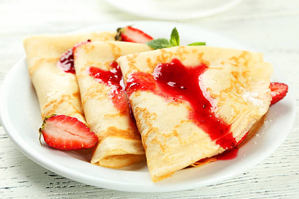 istock Pancakes with strawberry on plate on white wooden backgound 535870281
