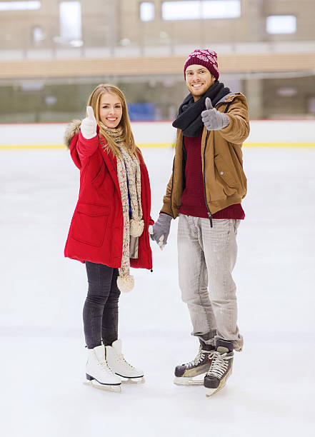 istock happy couple holding hands on skating rink 535871411