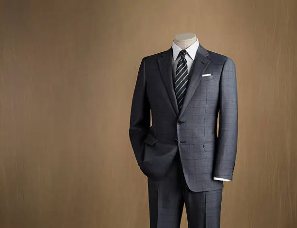 Mens two piece suit displayed on a mannequin photographed against a canvas background