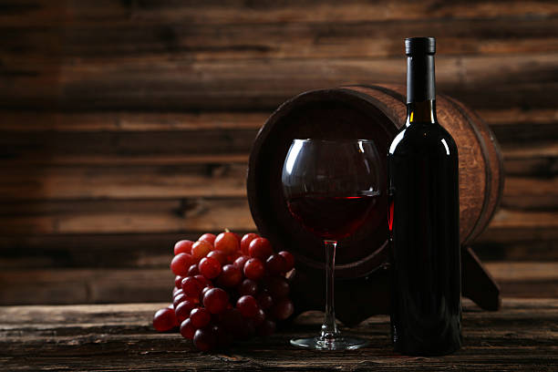 istock Glass of red wine with grapes 535872985