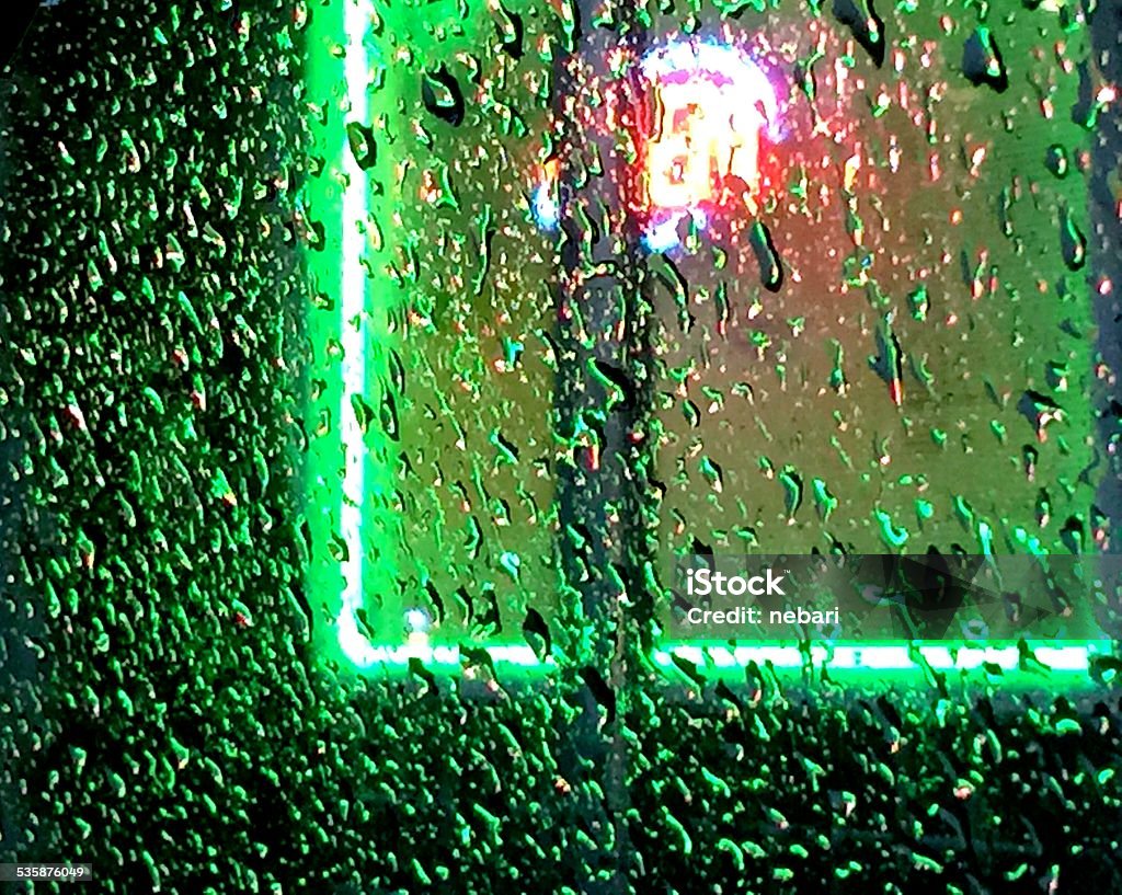 Restaurant neon from car glowing lights from a Chinese restaurant through a wet car window 2015 Stock Photo