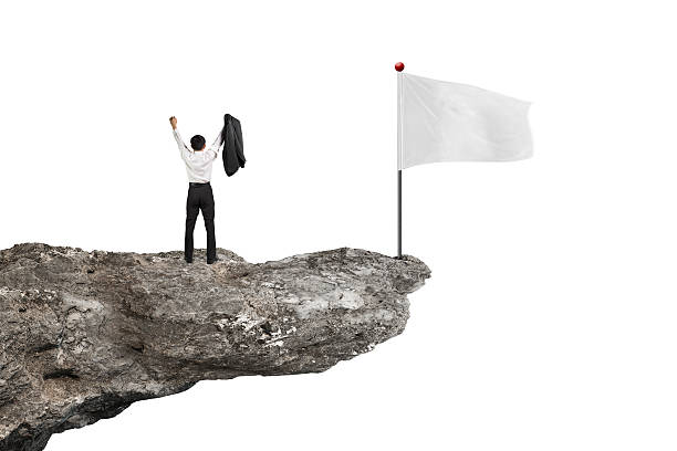 istock Man cheering on cliff with blank flag and white 535876193