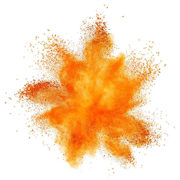 Photo of orange powder explosion isolated on white