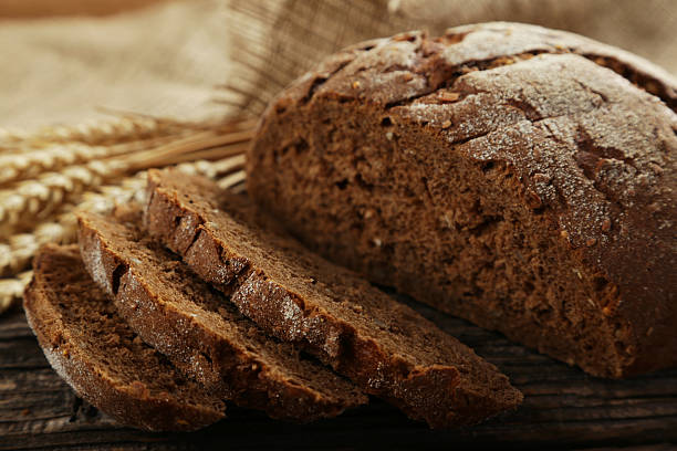 istock Freshly baked bread on brown wooden background 535887295