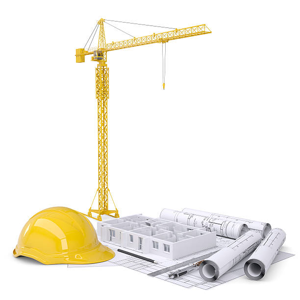 istock Apartment block under construction, crane, blueprints, drawing instruments, hard hat 535890423