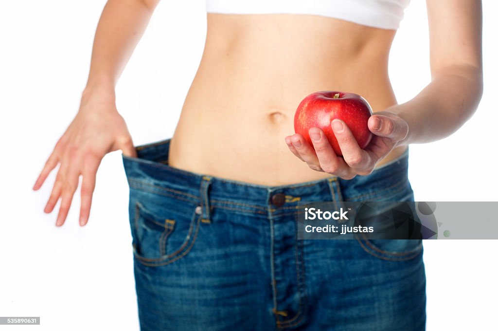 Slim woman with apple Slim woman holding apple in her hand 2015 Stock Photo