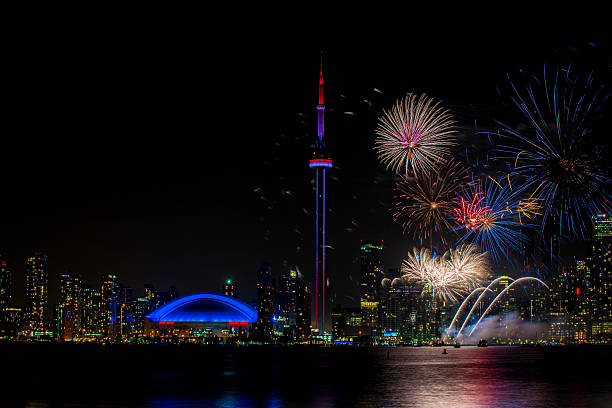 colorful fireworks with CN Tower at night colorful fireworks with CN Tower at night victoria day canada photos stock pictures, royalty-free photos & images
