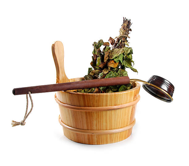 sauna accessories - bucket with birch broom and ladle, isolated on white background