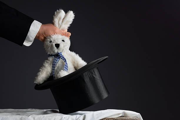 Man in suit pulling a rabbit out of the hat