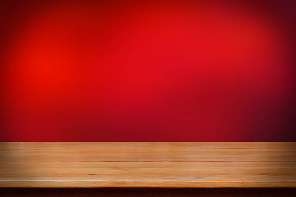 istock Wood table top on dark red abstract background 535897469