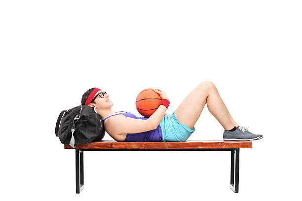istock Young man lying on a bench and holding basketball 535898247