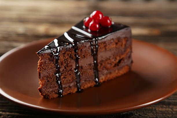 Dark chocolate cake on brown wooden background stock photo