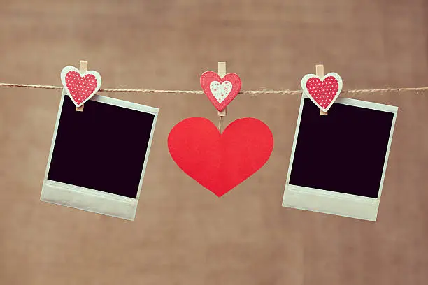 Photo of Two polaroid photo frames and red heart for valentines day