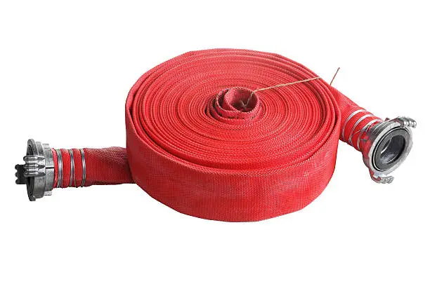 Rolled into a roll, red fire hose with aluminum connective couplings, Isolated on white background.