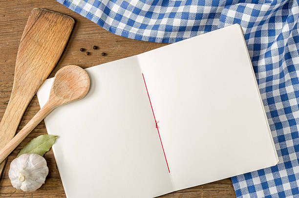 istock Book with wooden spoons on a blue checkered tablecloth 535898791