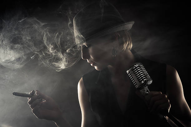 jazz singer with cigar and microphone jazz singer with cigar and microphone on black background smoking women luxury cigar stock pictures, royalty-free photos & images