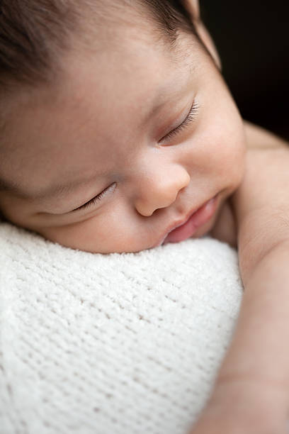 istock Newborn baby girl sleeping on shoulder 535911185