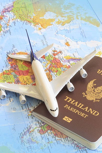 istock Toy plane resting on a thailand passport and world map 535912893