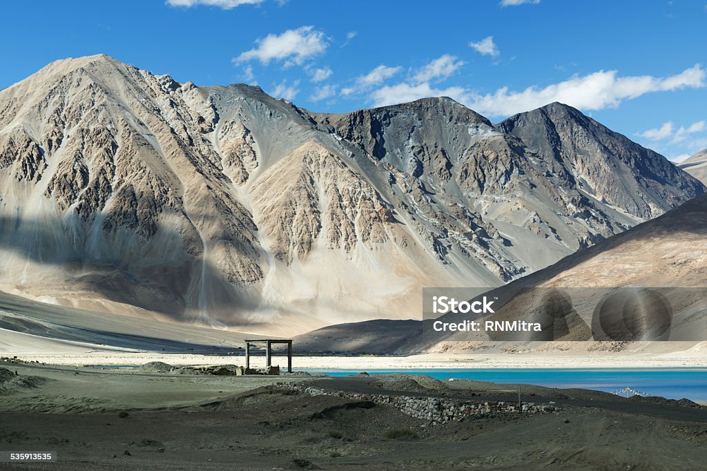 Mountains,Pangong tso (Lake),Leh,Ladakh,Jammu and Kashmir,India Mountains and Pangong tso (Lake). It is huge lake in Ladakh, altitude 4,350 m (14,270 ft). It is 134 km (83 mi) long and extends from India to Tibet. Leh, Ladakh, Jammu and Kashmir, India 2015 Stock Photo