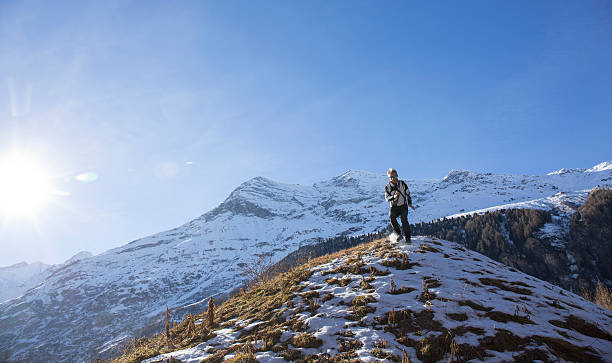 istock Trail runner bounds down snowy mountain slope 535914795